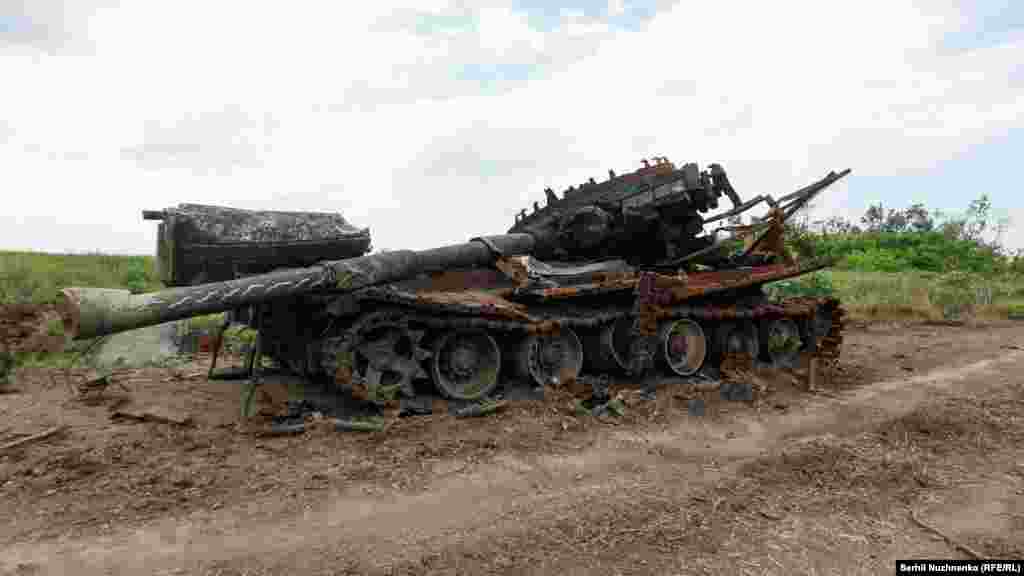 A destroyed Russian tank is seen near the village of Novodarivka.