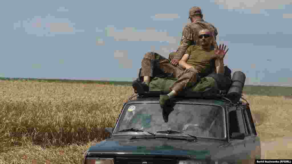 Ukrainian soldiers ride atop a car along a road near the recently retaken village of Novodarivka in the Zaporizhzhya region. Russian forces continue to occupy more than 45,000 square kilometers in southern Ukraine, not counting the Crimean Peninsula and the parts of southern Donetsk occupied since 2014.