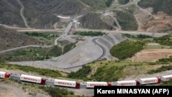 Armenian trucks carriyng humanitarian aid for Nagorno-Karabakh are seen stranded not far away from an Azerbaijani checkpoint set up at the entry of the Lachin corridor, July 30, 2023.