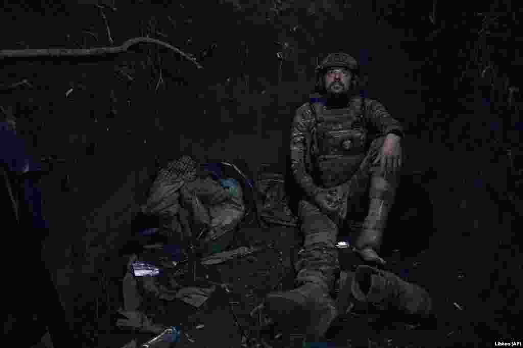 A Ukrainian soldier with the call sign "Hammer" looks up from his position in a trench on the front line in the Zaporizhzhya region. He lost his leg battling Russian troops and came back to the front with a prosthetic limb. In a June 30 interview, Ukraine's military commander-in-chief, Valeriy Zaluzhniy, expressed frustration at the slow deliveries of weaponry promised by the West and its criticism of Kyiv's progress, "Every day, every meter is given by blood." 