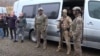 Azerbaijan - Azerbaijani officers escort Armenian POWs to the Armenian border, December 13, 2023.