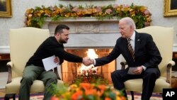 U.S. President Joe Biden (right) shakes hands with Ukrainian President Volodymyr Zelenskiy as they meet in the Oval Office of the White House in Washington on December 12.