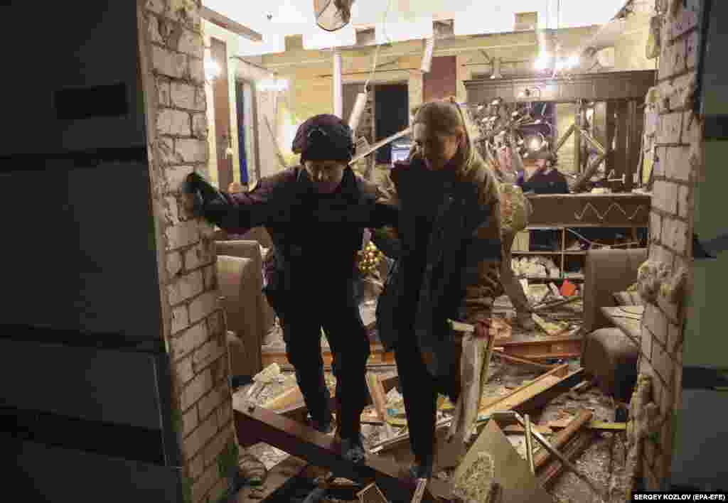A policeman helps a woman who was staying at the hotel during the attack. "Two missiles hit a hotel in the center of Kharkiv. There were no military personnel there. Instead, there were 30 civilians, 11 of whom were wounded," Mayor Ihor Terekhov posted on Telegram.