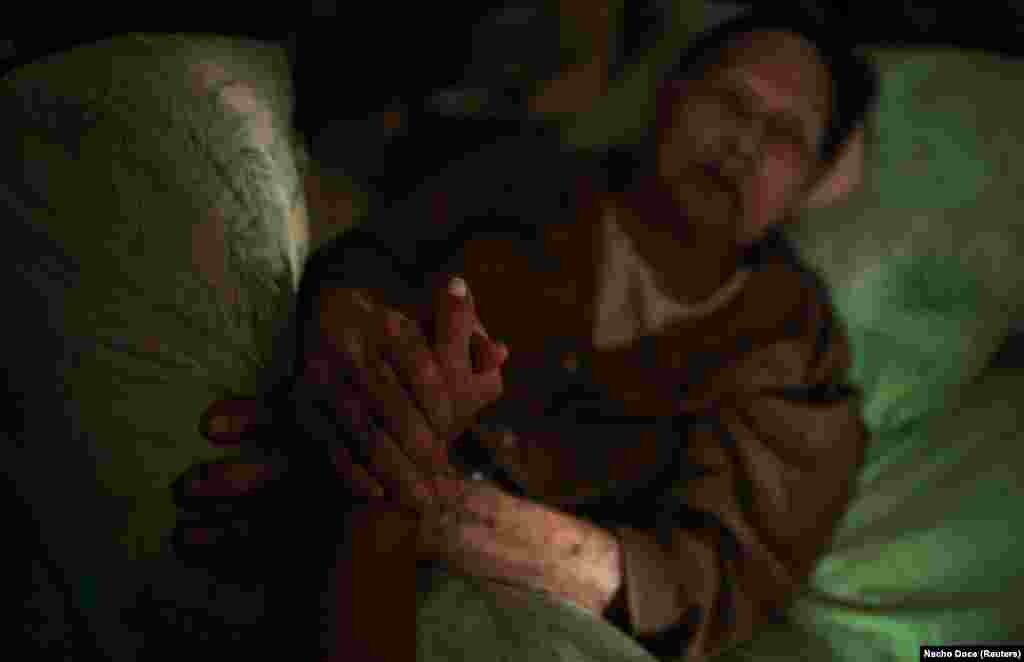 Ataiantz holds the hands of her grandmother. "She knows nothing about the war. I tell her that the military is training," she said.