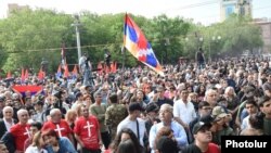 Armenia - An opposition supporter waves the Karabakh flag during an anti-government rally in Yerevan, May 1, 2022.