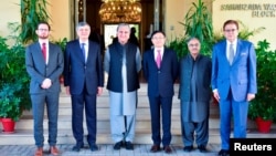 Pakistani Foreign Minister Shah Mahmood Qureshi (third left) with the envoys from the United States, China, and Russia before the "Troika plus" group conference in Islamabad on November 11.