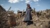 Iran -- An earthquake victim stands near damaged houses in the earthquake-stricken town of Azerbaijan, 13Aug2012