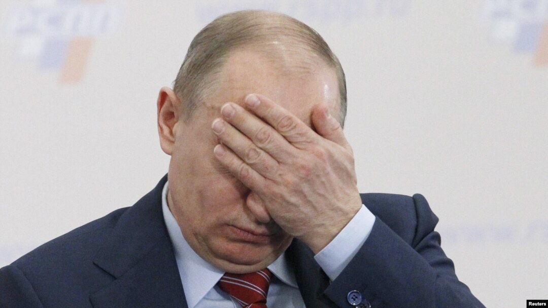 Prime Minister Vladimir Putin covers his face during a conference of the Russian Union of Industrialists and Entrepreneurs in Moscow on February 9.