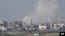 Smoke rises following an Israeli air strike in the Gaza Strip, as seen from southern Israel, on October 28.