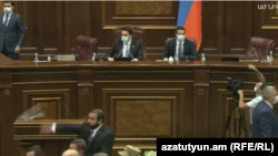 Pro-government and opposition lawmakers threw water battles at each other during a brawl in the Armenian parliament on August 25, 2021 