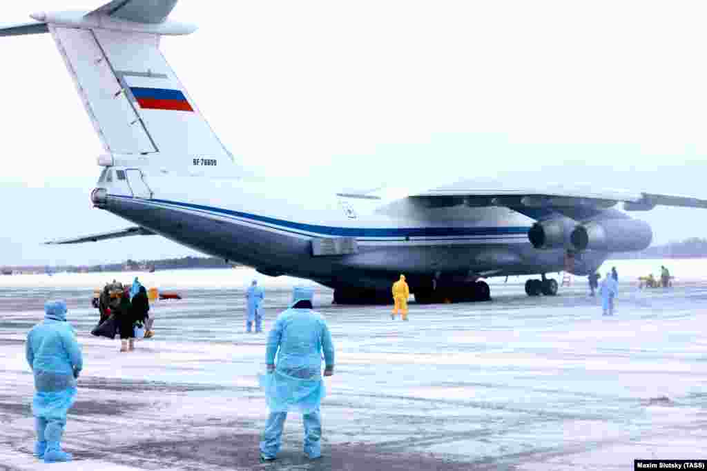 Medical personnel at an airport outside Tyumen, Russia, prepare for the arrival of Russian citizens from China.