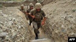 Nagorno-Karabakh -- Armenian soldiers of the self-proclaimed republic of Nagorno-Karabagh walk in a trench at the frontline on the border with Azerbaijan near the town of Martakert, 06Jul2012