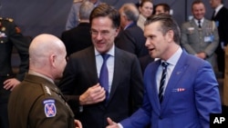 US Secretary of Defense Pete Hegseth (right) speaks with NATO Secretary-General Mark Rutte (center), and NATO's supreme allied commander for Europe, General Christopher Cavoli during an alliance meeting in Brussels last month. 