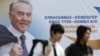 Молодые люди проходят мимо билборда с изображением президента Казахстана Нурсултана Назарбаева. Алматы, 22 февраля 2011 года. 