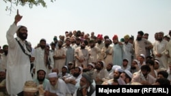 A tribal jirga or council in the Khyber tribal district debate the fate of minority Sikhs threatened by a fanatical cleric in 2002.