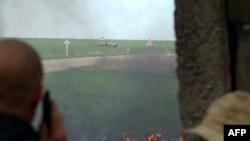 Ukrainian special forces approach residents waving the Ukrainian national flag.