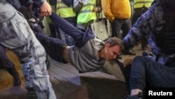 Egy moszkvai mozgósítás elleni tüntetésről szállít el egy résztvevőt a rendőrség 2022. szeptember 21-én