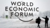 SWITZERLAND -- A security guard show the way to a man outside of the Davos Congress Centre under snow ahead of the opening of the World Economic Forum (WEF) 2018 annual meeting, in Davos, January 22, 2018