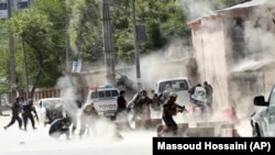 FILE: Afghan Security forces at the site of a suicide attack in Kabul on April 30.