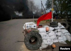 A checkpoint set on fire and abandoned by pro-Russian separatists.