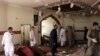 Members of a bomb-disposal unit survey the site after a blast at a mosque in Kuchlak, on the outskirts of Quetta, on August 16.