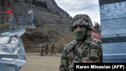 NAGORNO-KARABAKH -- Azerbaijani soldiers patrol at a checkpoint on a road outside the town of Shushi (Susa), November 26, 2020.
