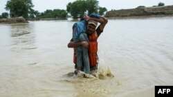 A Pakistani soldier rescues a child from the flood-affected Rajanpur district in Punjab Province on August 2.