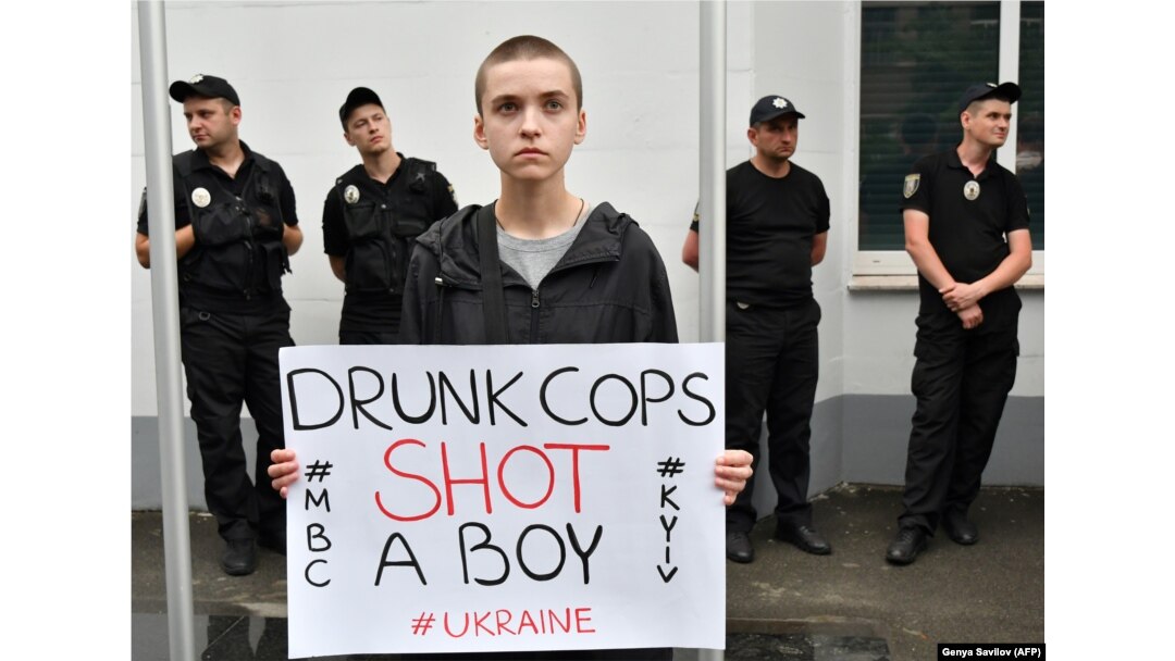 A protester holds a placard during a demonstration in front of the Interior Ministry in Kyiv on June 4.