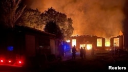 Smoke and flames rise after Ukrainian President Volodymyr Zelenskiy said a Russian-guided aerial bomb hit a blood-transfusion center, in the town of Kupyansk in northeastern Ukraine on August 5.