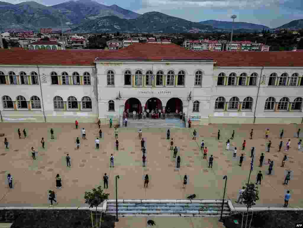 High school students social distance on the first day of the new academic year in Drama, Greece, during the COVID-19 pandemic. Schools reopened on September 14 amid concerns over a new spike in infections along with resistance by some parents to a regulation stipulating that all children and adults must wear protective face masks.