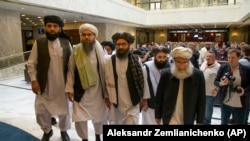 FILE: Mullah Abdul Ghani Baradar, the Taliban group's top political leader, third from left, arrives with other members of the Taliban delegation for talks in Moscow in May 2019.