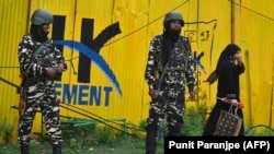Indian security personnel stand guard near a closed school in Srinagar on August 19.
