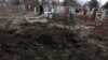 Воронка от снаряда на кладбище поселка Сартана