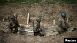 Nagorno-Karabakh -- Ethnic Armenian soldiers walk in a trench at an artillery positions near the Nagorno-Karabakh's town of Martuni, April 7, 2016