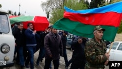 Men carry the coffin of an Azerbaijan's serviceman, who was killed on April 2 during clashes between Armenian and Azeri forces in Nagorny Karabakh, during his funeral in Terter on April 3, 2016.