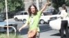 Armenia -- Mariam Sukhudian, a civic activist charged with "false deninciation," greets supporters as she heads to a police station in Yerevan for interrogation on August 19, 2009.