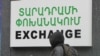Armenia - A schoolboy walks past a currency exchange sign in Yerevan, 17Dec2014.