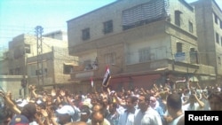 Demonstrators march through the streets of Damascus on July 1.