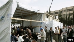 Iraqi refugees line up at a UNHCR registration center in Syria