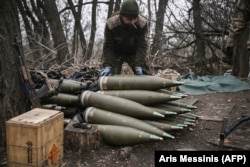 A Ukrainian soldier prepares 155mm artillery shells near Bakhmut in March 2023.