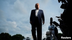 US President Donald Trump speaks to reporters as he arrives on the South Lawn of the White House on May 4.
