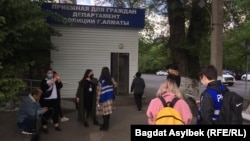 Qaznews24 паблигінің жетекшісі Темірлан Еңсебек жеткізілген Алматыдағы полиция департаменті алдына жиналған белсенділер. 15 мамыр, 2021 жыл.