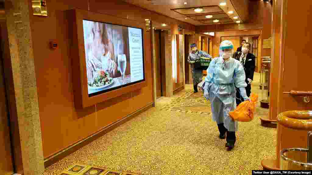 Men in protective clothing walk inside the Diamond Princess cruise ship. Nearly 3,700 people have been confined to the vessel since some passengers were diagnosed with the highly contagious coronavirus on February 4.