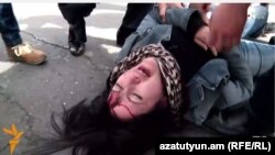 Armenia - Opposition protester Ruzanna Yegnukian is injured during a scuffle with riot police, Yerevan, 24March2016.