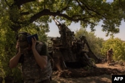 A Ukrainian soldier of the 43rd Artillery Brigade fires a self-propelled artillery 2S7 Pion toward Russian positions in the Pokrovsk district of eastern Donetsk region in August 2024.