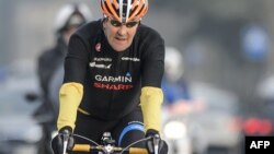 U.S. Secretary of State John Kerry rides his bike in Lausanne, Switzerland, in March.