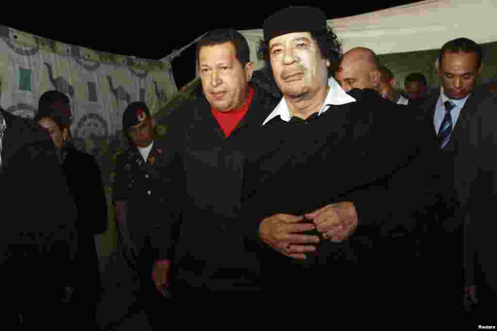 Chavez is greeted by then-Libyan leader Muammar Qaddafi (right) upon his arrival in Tripoli in October 2010.