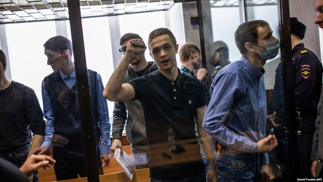 Alleged members of a left-wing group react after being given lengthy sentences on terrorism charges that have been heavily criticized by rights groups. 