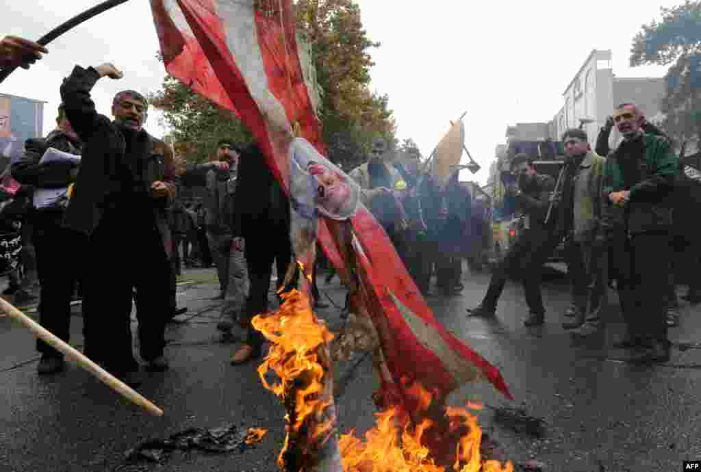 Iranians burn U.S. flags outside the former U.S. Embassy in Tehran on November 4, 2014.